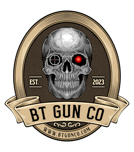 Logo of BT Gun Co featuring a detailed skull with a crosshair in the left eye socket and a red glowing light in the right eye socket. The skull is enclosed in an oval frame with "EST. 2023" on either side. A ribbon below reads "BT GUN CO" with a website link underneath.