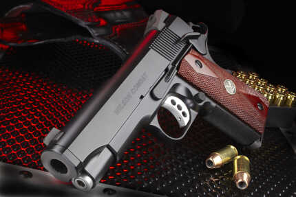 Wilson Combat handgun with bullets on textured surface