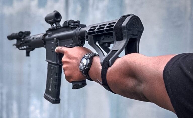 Close-up of a pistol with a brace attached, highlighting the regulatory complexities