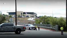 School security guard standing near school entrance, ensuring student safety