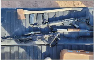 AR-15 style rifle with border patrol background, representing gun control debate