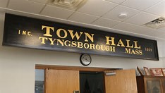 group of people discussing firearms in town hall meeting setting