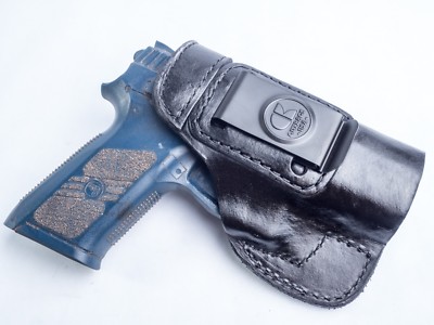 9mm semi-automatic pistol with concealed carry holster on table