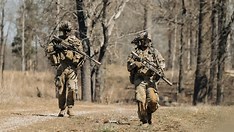 US Army soldiers conducting rifle training exercises on a military range.