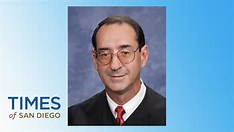 Federal judge presiding over a courtroom hearing with a gavel on the bench