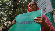Protestors holding signs advocating for freedom of speech near the Supreme Court.