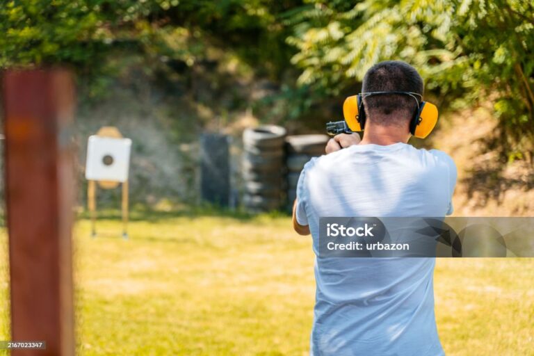 A shooter practicing proper stance and sight alignment with a semi-automatic pistol