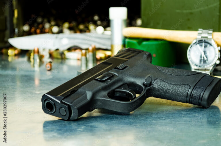 A 9mm semi-automatic handgun resting on a clean wooden surface