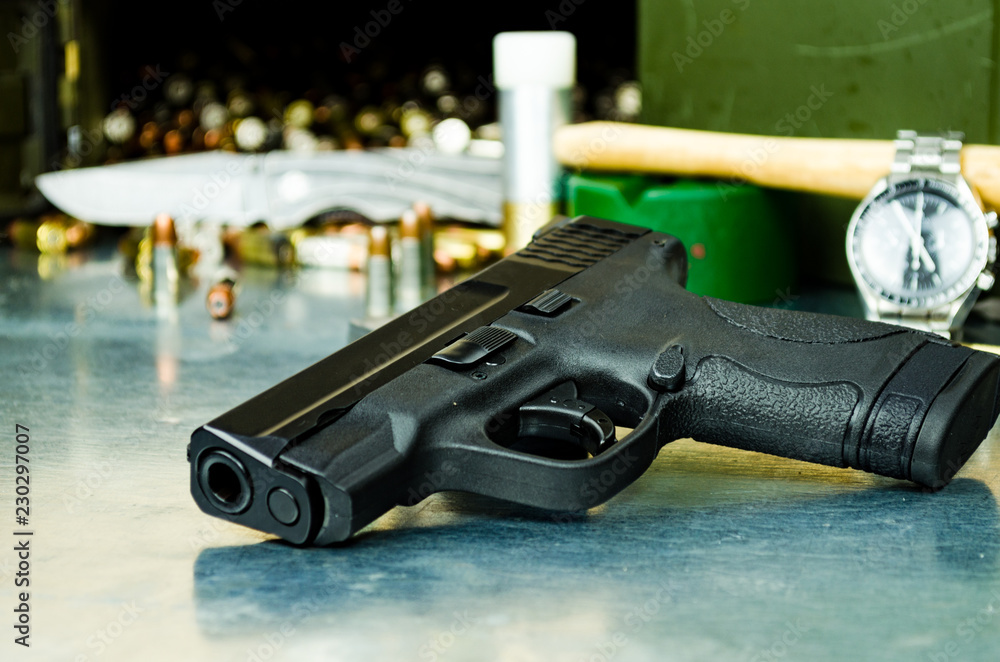 A 9mm semi-automatic handgun resting on a clean wooden surface