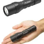 Surefire 6PX Tactical Flashlight, black angled view with textured body, shown beside a hand for scale