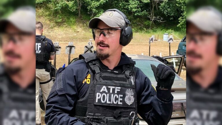 Law enforcement officer with service handgun in a city environment