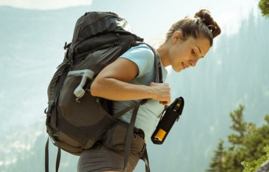 Woman holding bear spray, protective gear for self-defense