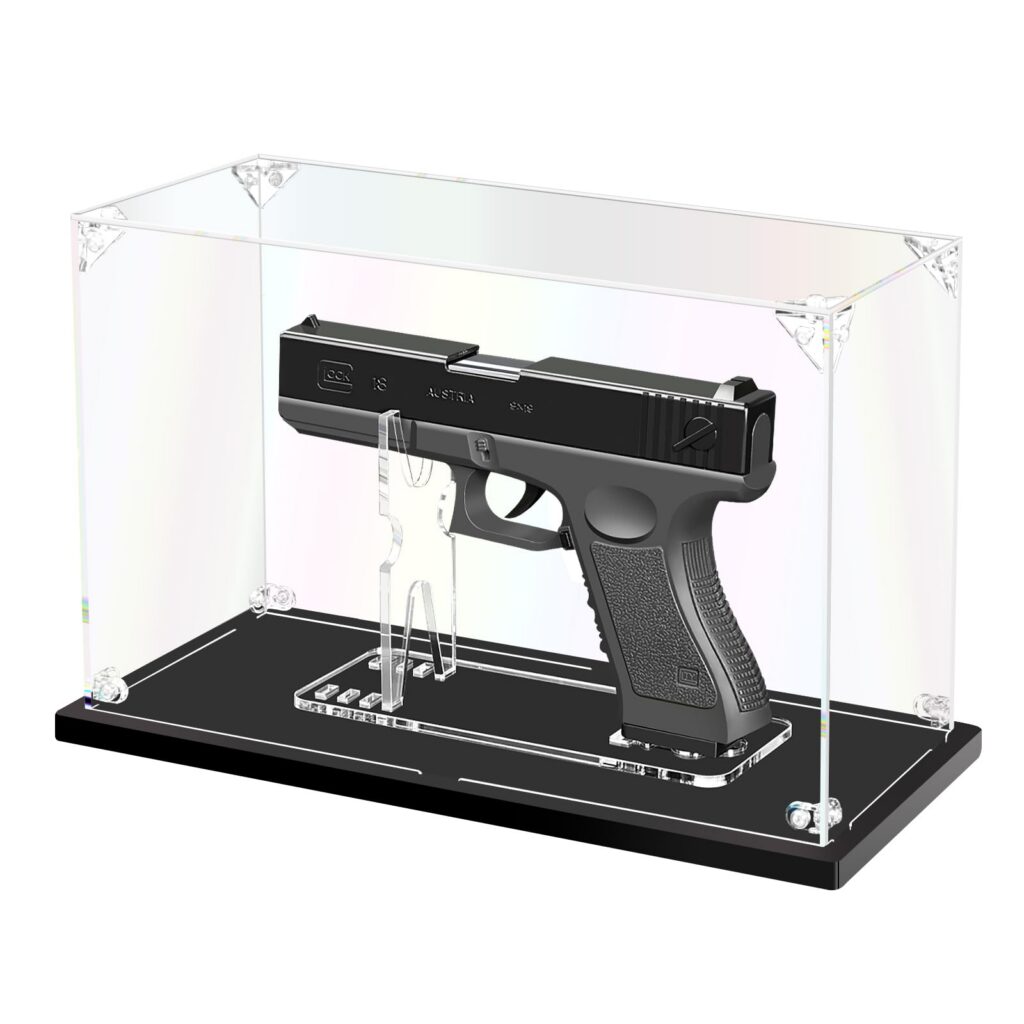 A modern semi-automatic handgun resting on a wooden display surface