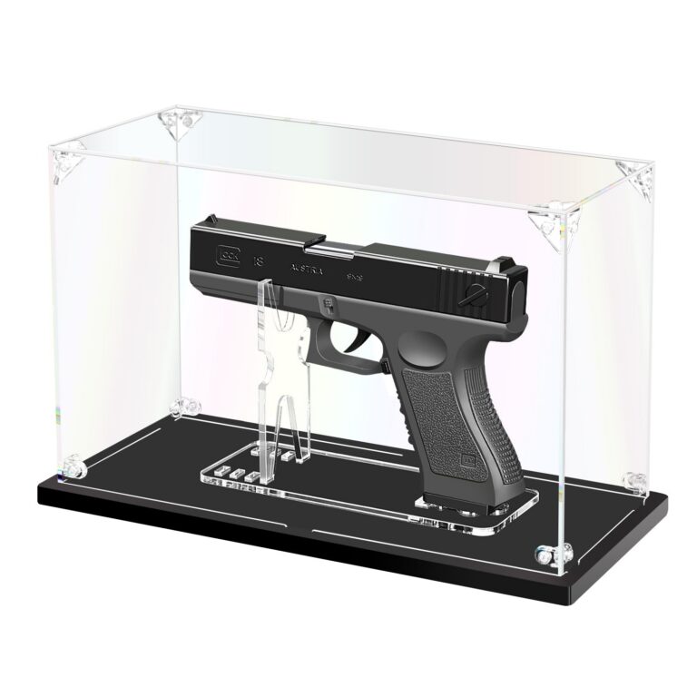 A modern semi-automatic handgun resting on a wooden display surface