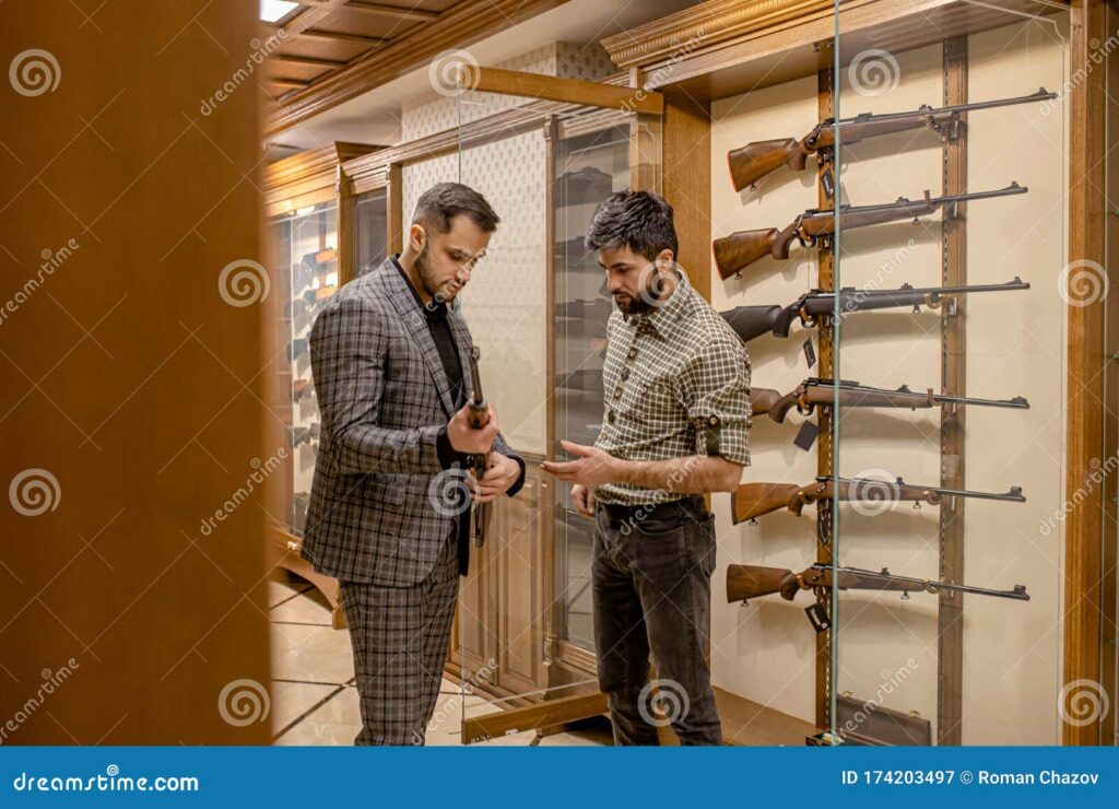 Young adult presenting identification to licensed dealer at firearm counter