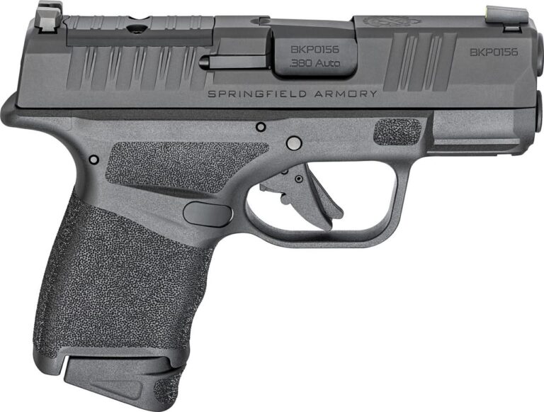 A compact .380 ACP semi-automatic pistol resting on a wooden surface