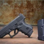 Pachmayr/Tacstar Grip Extender Glock 42, black extender on magazine beside a black pistol