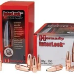 Hornady InterLock Bullets, copper-coloured pointed bullets beside red retail boxes
