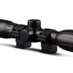 Konus KONUSFIRE 4x32mm Rifle Scope, black angled side view with adjustment turrets and mounting rings