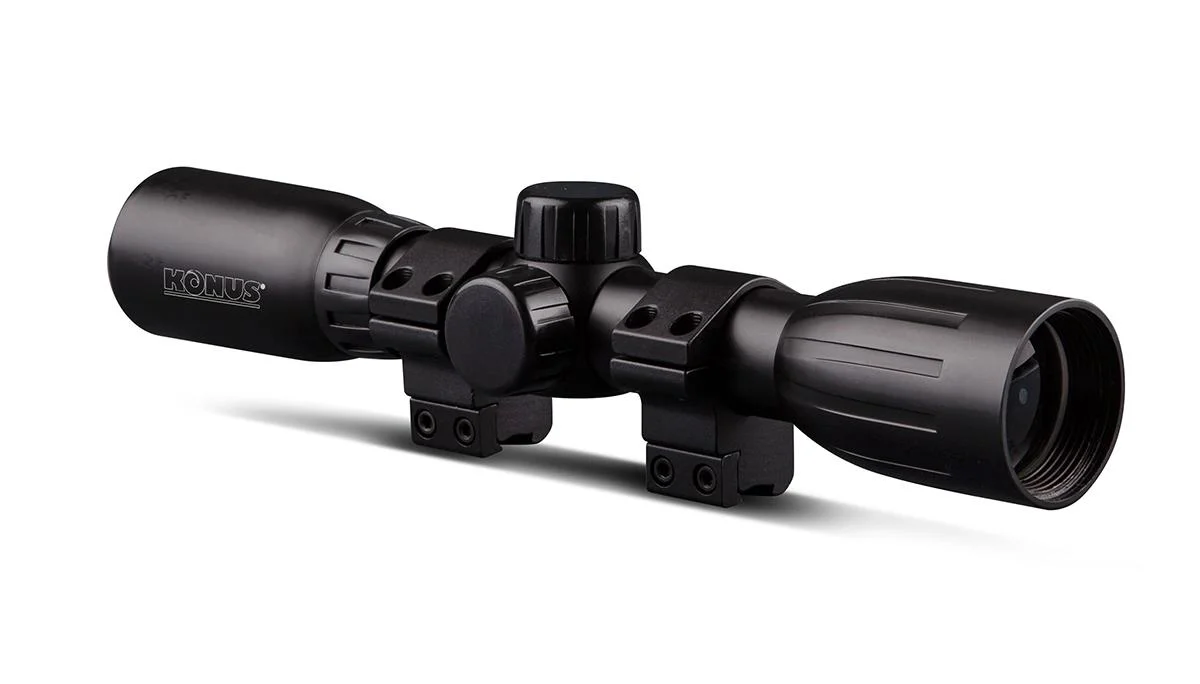 konus-konusfire-4x32mm-rifle-scope-review-primary Konus KONUSFIRE 4x32mm Rifle Scope, black angled side view with adjustment turrets and mounting rings