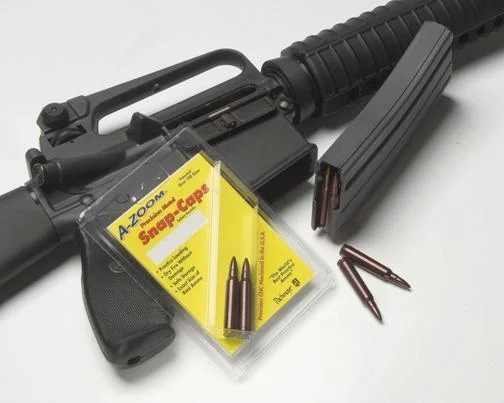 Pachmayr/Tacstar A-Zoom Metal Snap Caps, red caps and yellow package beside a black rifle