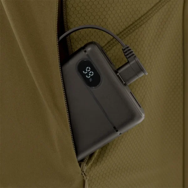 Gsm Muddy Nucleus brown clay shirt, close-up of zippered pocket holding a connected power bank