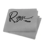 OTIS ROSE BY SIG SILICONE GUN CLOTH, gray folded cloth with black Rose logo and scalloped edges