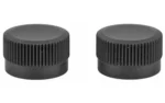 TRIJICON ACOG ADJ CAPS two black round ribbed adjustment caps, angled top view