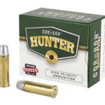 CORBON 44MAG Hunter HC, green and white ammunition box beside two brass cartridges