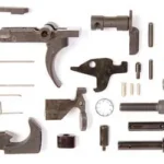 LBE LPK 556 top view of assorted dark metal lower parts, pins, detents and springs