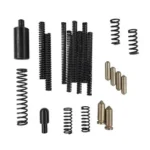 KAK AR-15 MISSING PARTS KIT, black springs, pins and brass pieces arranged in groups