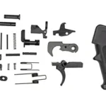 ODIN Enhanced LPK black lower parts kit arranged beside a textured pistol grip