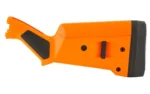 MAGPUL SGA REM 870 STK, orange right-side view with black grip panels and recoil pad