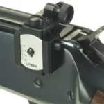 Lyman Receiver Peep Sights 66 Receiver Peep Sights, black rear sight mounted on a rifle receiver