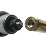 Lyman Primer Pocket Uniformer - Large, close-up of black tool tip beside a brass case head
