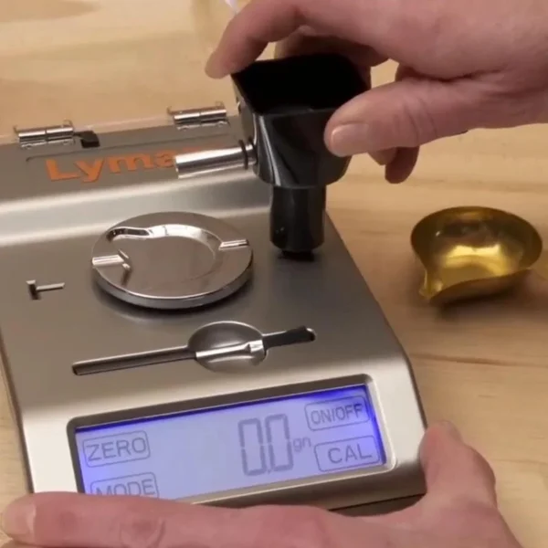 Lyman Gen6 Compact Powder System close-up with digital display, metal pan and hand on dispenser