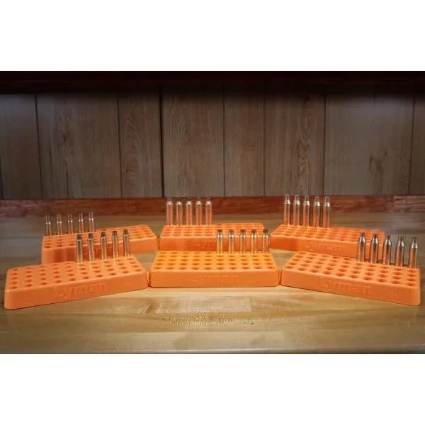 Lyman Custom Fit Loading Block, orange loading blocks holding cartridges on a bench