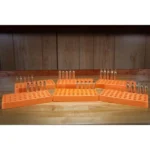 Lyman Custom Fit Loading Block, orange blocks holding cartridges on a wooden bench