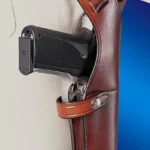 Bianchi Model X15 Vertical Shoulder Holster, tan leather side view with pistol and shoulder straps
