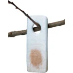 Wildlife Research Pro-Wick, white scent wick hanging from a branch with brown stain
