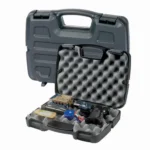 Plano Protector Single Scoped Pistol gray hard case open with egg-crate foam and assorted contents