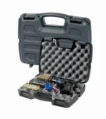 Plano Protector Single Scoped Pistol gray hard case open with egg-crate foam and assorted contents