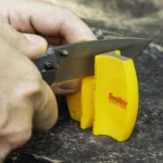 Smith's 2-Step Knife Sharpener, yellow sharpener in use on a knife blade