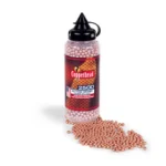 Crosman Copperhead BBs, clear bottle with black cap and copper-coloured BBs spilling out