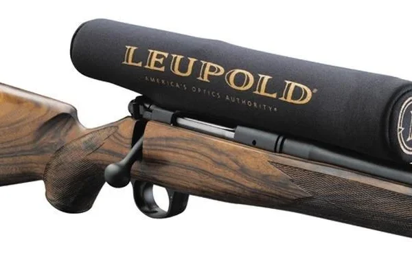 Leupold Neoprene Scope Cover, black side view fitted over a rifle scope with gold logo