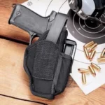 Michaels Of Oregon Uncle Mike's Ambidextrous Hip Holster in black beside a silver revolver