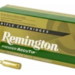 Remington Premier AccuTip Varmint green ammunition box with two brass cartridges
