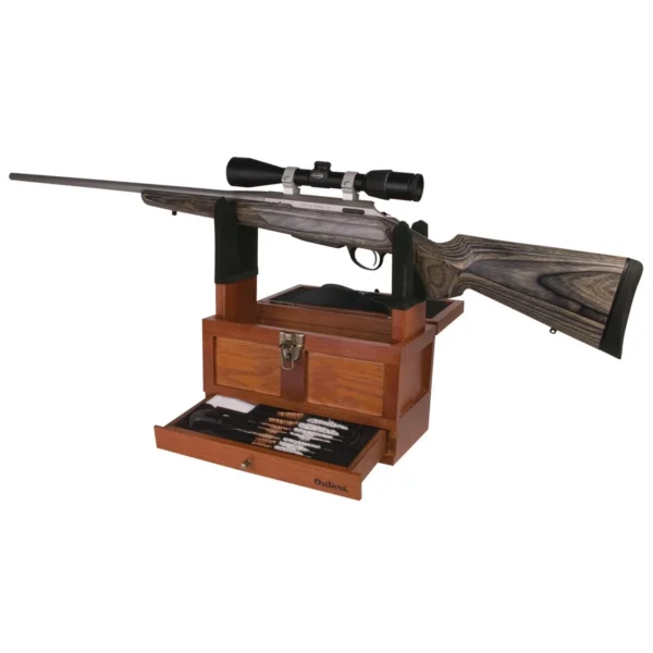 Outers Universal Wood Gun Cleaning Tool Box, open wood case supporting a scoped rifle