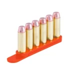 Tuff Products Quickstrips orange speed strip holding six brass cartridges, angled side view