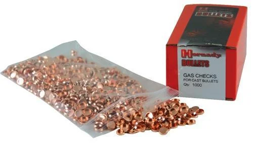 Hornady Crimp-On Gas Checks 7mm copper-colored checks spilling from a clear bag beside red box